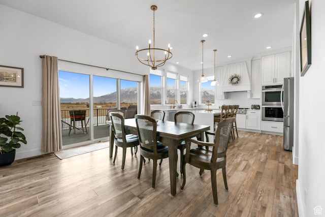 3932 W 2875 N, Plain City, UT 84404 - dining room with light wood-style floors, plenty of natural light, a chandelier, recessed lighting, and a mountain view