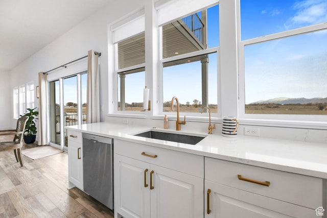 3932 W 2875 N, Plain City, UT 84404 - kitchen featuring dishwasher, a sink, wood finished floors, white cabinetry, and light countertops