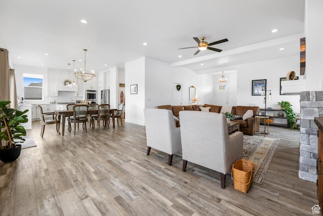 3932 W 2875 N, Plain City, UT 84404 - living room featuring a chandelier, light wood-style floors, recessed lighting, a fireplace, and ceiling fan