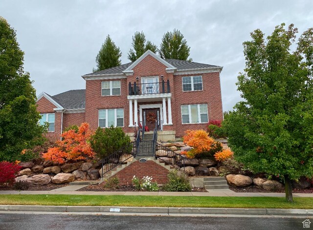 434 S Cardon Ridge Dr, Smithfield, UT 84335 - colonial-style house with a balcony and brick siding