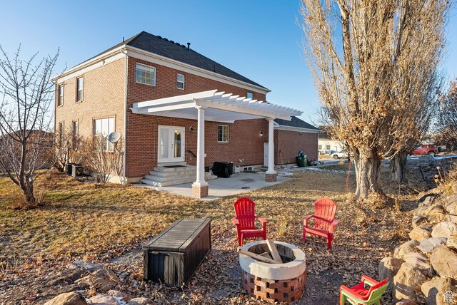 434 S Cardon Ridge Dr, Smithfield, UT 84335 - back of house featuring a fire pit, brick siding, a pergola, and a patio area