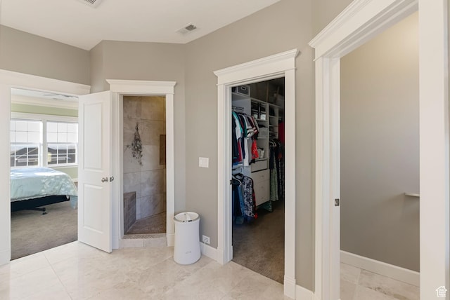 434 S Cardon Ridge Dr, Smithfield, UT 84335 - unfurnished bedroom featuring a walk in closet, light carpet, baseboards, and a closet