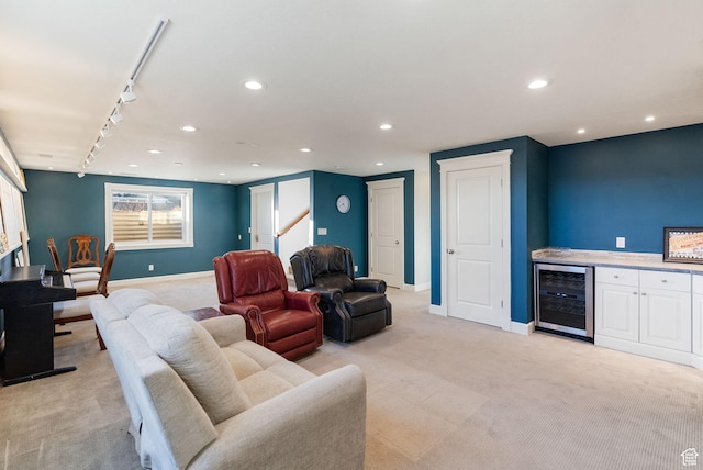 434 S Cardon Ridge Dr, Smithfield, UT 84335 - living area with beverage cooler, light colored carpet, rail lighting, baseboards, and recessed lighting
