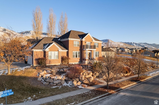 434 S Cardon Ridge Dr, Smithfield, UT 84335 - view of front facade featuring a balcony, brick siding, a mountain view, and roof with shingles