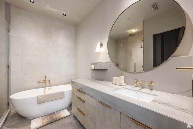 1920 E Rodeo Walk Dr Unit 516, Holladay, UT 84117 - full bathroom featuring tile walls, a soaking tub, a shower stall, and vanity