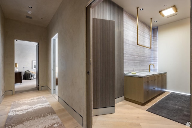 1920 E Rodeo Walk Dr Unit 516, Holladay, UT 84117 - corridor featuring light wood-style flooring and a sink