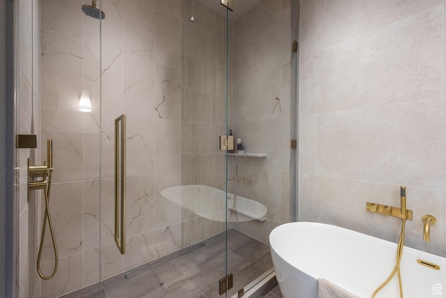 1920 E Rodeo Walk Dr Unit 516, Holladay, UT 84117 - full bathroom with tile walls, a stall shower, and a freestanding tub