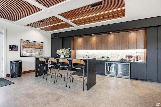 1920 E Rodeo Walk Dr Unit 516, Holladay, UT 84117 - indoor bar with beverage cooler, tasteful backsplash, baseboards, and light tile patterned floors