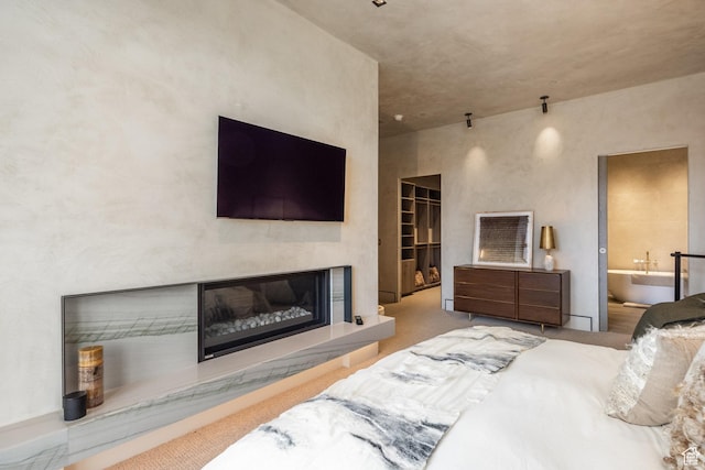 1920 E Rodeo Walk Dr Unit 516, Holladay, UT 84117 - bedroom with a glass covered fireplace, carpet floors, and ensuite bathroom