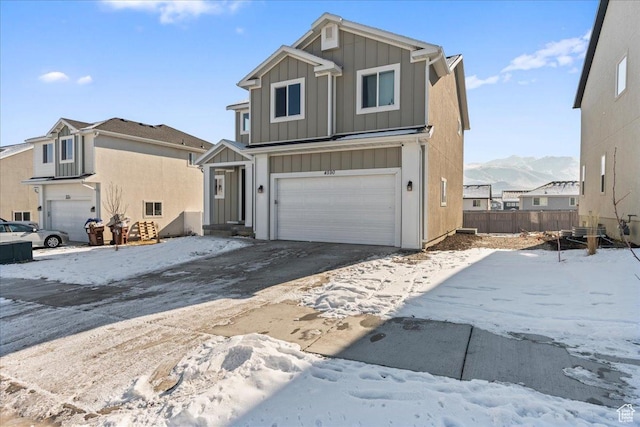 front facade with a garage and a mountain view