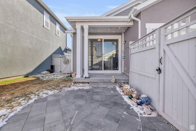 view of exterior entry featuring a patio area