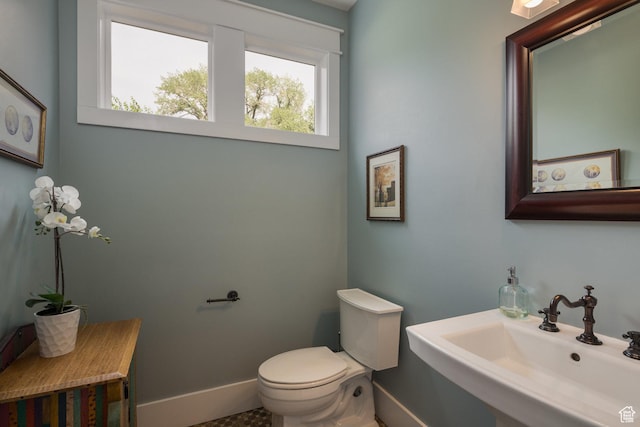 424 E Secret Cove Ct, Moab, UT 84532 - half bathroom with toilet, baseboards, and a sink
