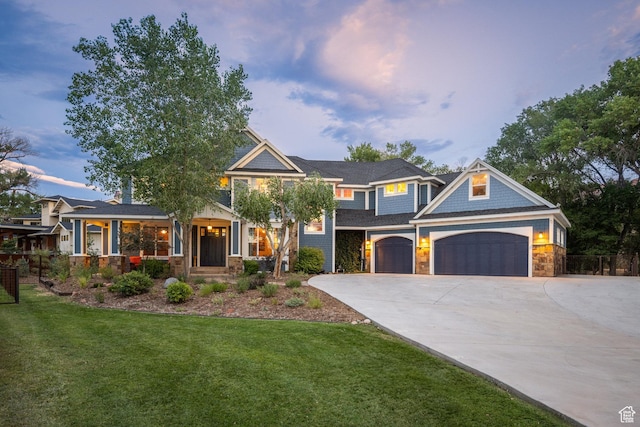 424 E Secret Cove Ct, Moab, UT 84532 - craftsman-style home featuring fence, stone siding, a garage, a front yard, and concrete driveway