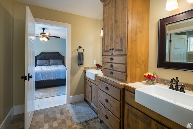 424 E Secret Cove Ct, Moab, UT 84532 - full bath with double vanity, ceiling fan, a sink, and ensuite bathroom