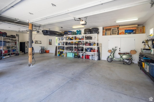 424 E Secret Cove Ct, Moab, UT 84532 - garage featuring stainless steel fridge and a garage door opener