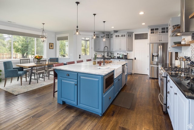 424 E Secret Cove Ct, Moab, UT 84532 - kitchen with blue cabinets, appliances with stainless steel finishes, a sink, dark wood-style floors, and recessed lighting