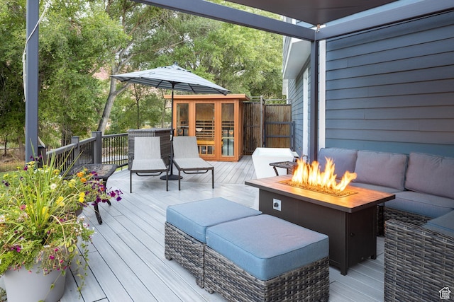 424 E Secret Cove Ct, Moab, UT 84532 - wooden deck featuring an outdoor living space with a fire pit