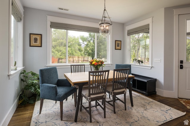 424 E Secret Cove Ct, Moab, UT 84532 - dining space featuring an inviting chandelier, baseboards, wood finished floors, and visible vents