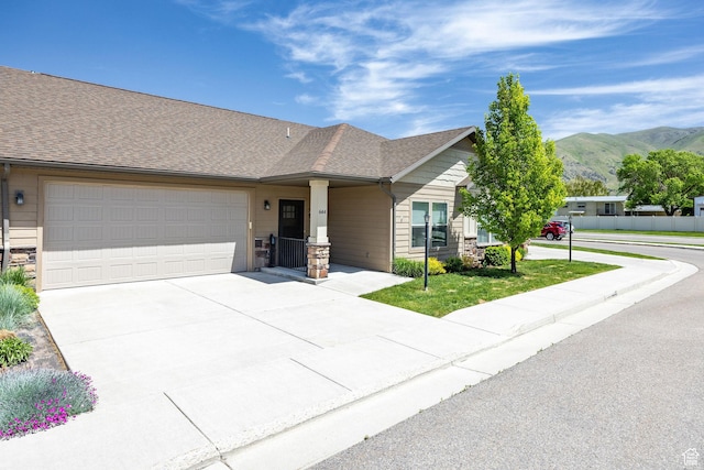 644 E 50 S, Hyrum, UT 84319 - view of front of property featuring a mountain view, a garage, concrete driveway, and roof with shingles