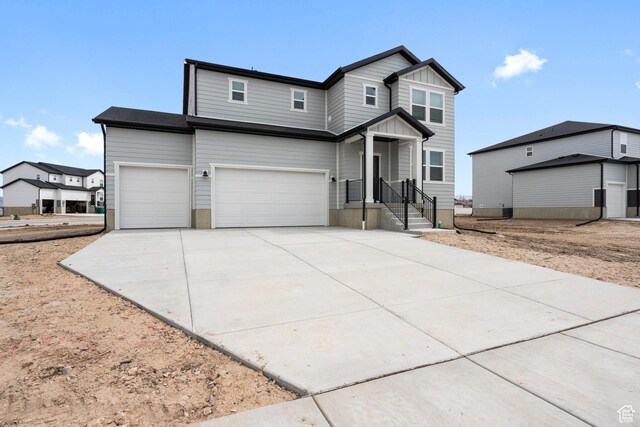 3141 W 3500 S Unit 113, West Haven, UT 84401 - view of front facade with a garage, board and batten siding, and concrete driveway
