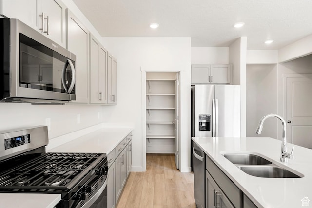 3141 W 3500 S Unit 113, West Haven, UT 84401 - kitchen featuring light wood-style floors, recessed lighting, light countertops, a sink, and stainless steel appliances