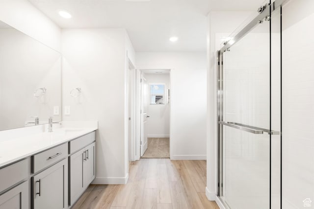 3141 W 3500 S Unit 113, West Haven, UT 84401 - bathroom with vanity, baseboards, a stall shower, and wood finished floors