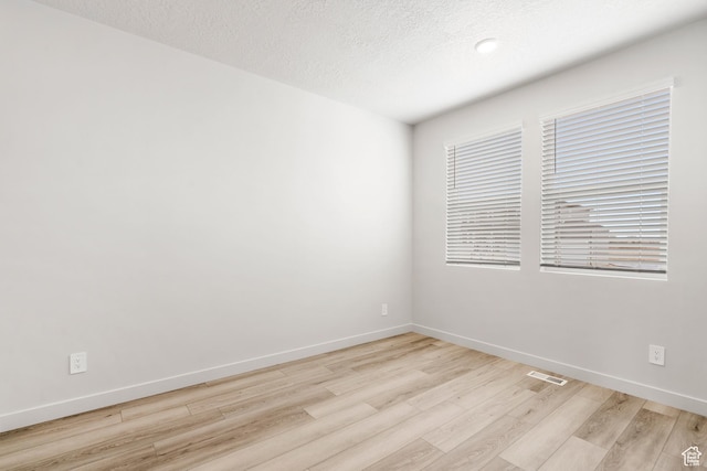 3141 W 3500 S Unit 113, West Haven, UT 84401 - spare room with baseboards, visible vents, and light wood finished floors