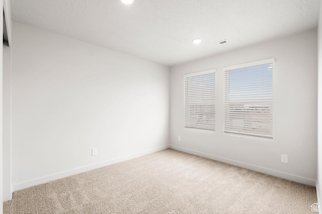 3141 W 3500 S Unit 113, West Haven, UT 84401 - unfurnished room with baseboards, light carpet, a textured ceiling, and visible vents