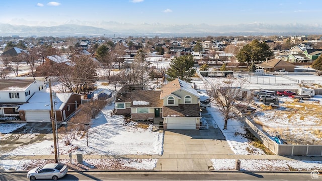 snowy aerial view featuring a mountain view