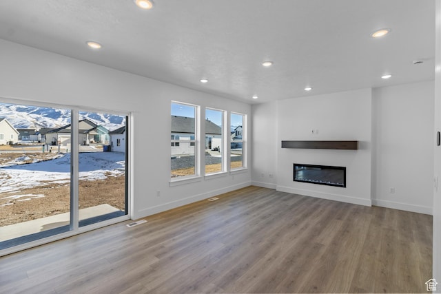 unfurnished living room featuring wood-type flooring