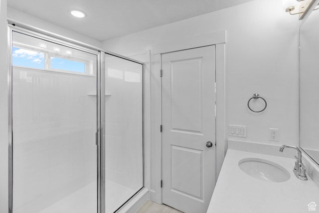 bathroom with walk in shower and vanity