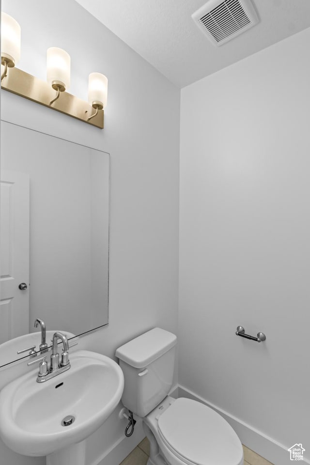 bathroom featuring sink and toilet