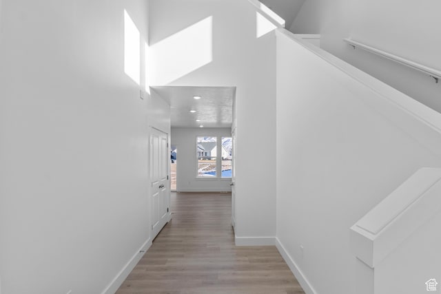 corridor with light wood-type flooring