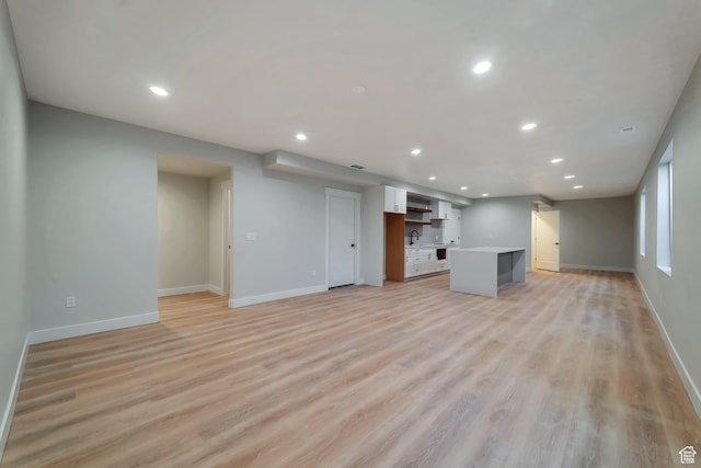 1521 E Thorpe Dr, Eagle Mountain, UT 84005 - unfurnished living room with recessed lighting, baseboards, and light wood finished floors