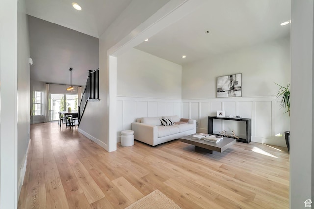 1521 E Thorpe Dr, Eagle Mountain, UT 84005 - living room with light wood-style flooring, a decorative wall, recessed lighting, and wainscoting