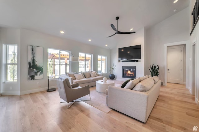 1521 E Thorpe Dr, Eagle Mountain, UT 84005 - living area with a glass covered fireplace, recessed lighting, light wood-type flooring, and a ceiling fan