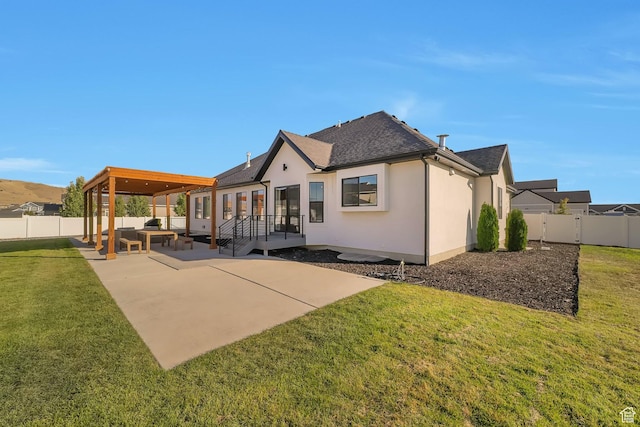 1521 E Thorpe Dr, Eagle Mountain, UT 84005 - rear view of property featuring a patio area, a yard, a fenced backyard, and stucco siding