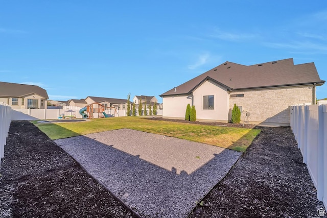 1521 E Thorpe Dr, Eagle Mountain, UT 84005 - view of yard featuring a playground, a fenced backyard, and a residential view