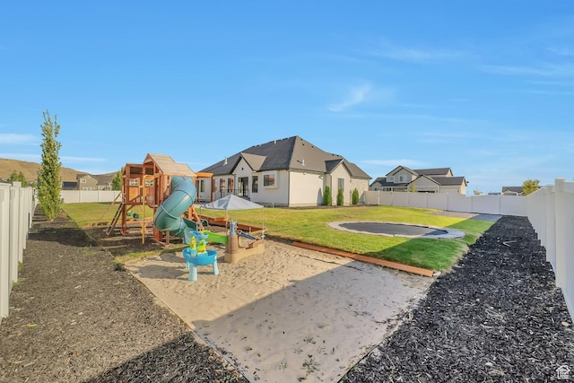 1521 E Thorpe Dr, Eagle Mountain, UT 84005 - view of jungle gym featuring a residential view, a lawn, and a fenced backyard