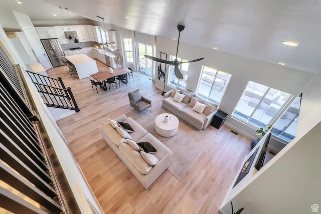 1521 E Thorpe Dr, Eagle Mountain, UT 84005 - living room featuring visible vents, recessed lighting, light wood-type flooring, and vaulted ceiling