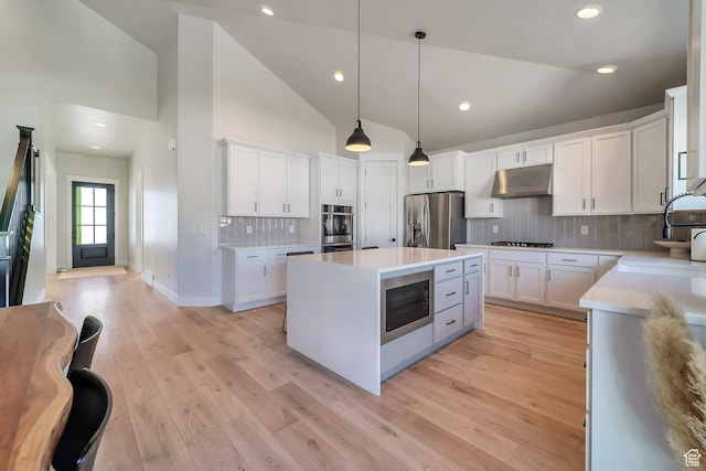 1521 E Thorpe Dr, Eagle Mountain, UT 84005 - kitchen with a sink, white cabinets, under cabinet range hood, appliances with stainless steel finishes, and a center island