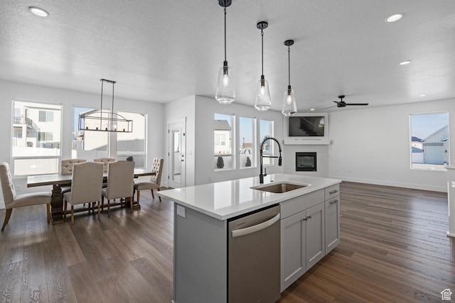 1504 S Lukas Ln, Saratoga Springs, UT 84045 - kitchen with dark hardwood / wood-style floors, sink, hanging light fixtures, stainless steel dishwasher, and a center island with sink