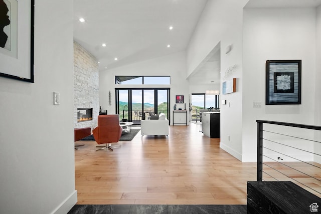 11515 N White Tail Ct, Hideout, UT 84036 - living area with high vaulted ceiling, baseboards, wood finished floors, recessed lighting, and a stone fireplace