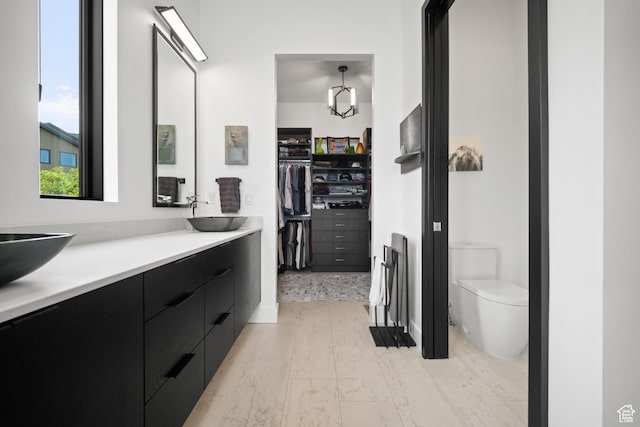 11515 N White Tail Ct, Hideout, UT 84036 - full bath with double vanity, a sink, toilet, and a spacious closet