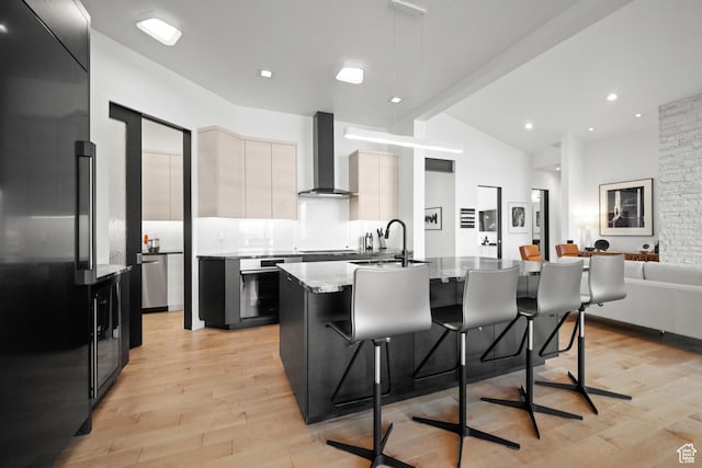 11515 N White Tail Ct, Hideout, UT 84036 - kitchen featuring a sink, light wood finished floors, wall chimney range hood, modern cabinets, and appliances with stainless steel finishes