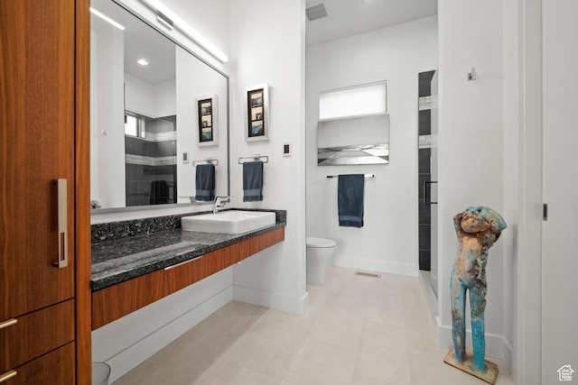 11515 N White Tail Ct, Hideout, UT 84036 - full bathroom featuring toilet, vanity, a shower with door, baseboards, and visible vents
