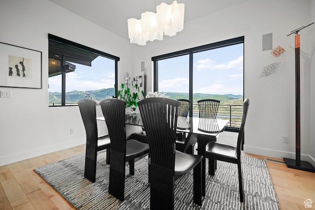 11515 N White Tail Ct, Hideout, UT 84036 - dining room featuring baseboards, light wood-style floors, and a mountain view