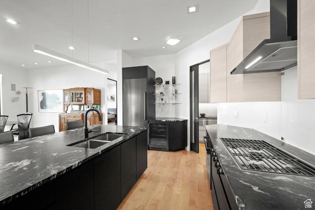 11515 N White Tail Ct, Hideout, UT 84036 - kitchen with wall chimney range hood, a sink, modern cabinets, and dark cabinets