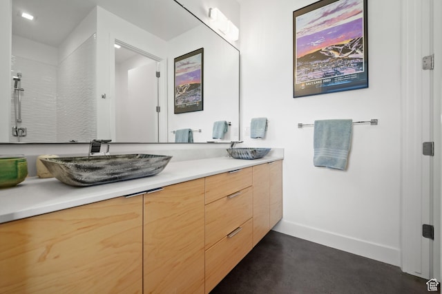 11515 N White Tail Ct, Hideout, UT 84036 - bathroom with baseboards, double vanity, a sink, and concrete flooring