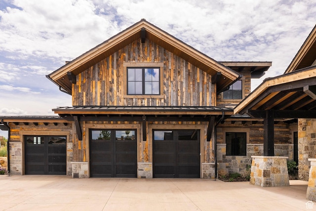 149 N Haystack Mountain Dr, Heber City, UT 84032 - view of front facade with stone siding, driveway, an attached garage, and board and batten siding